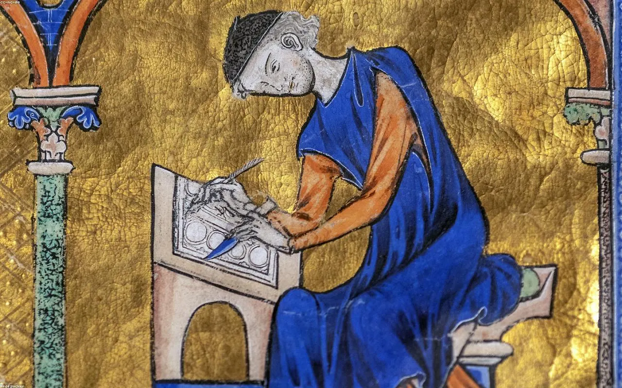 A quill pen resting on an old manuscript in warm light