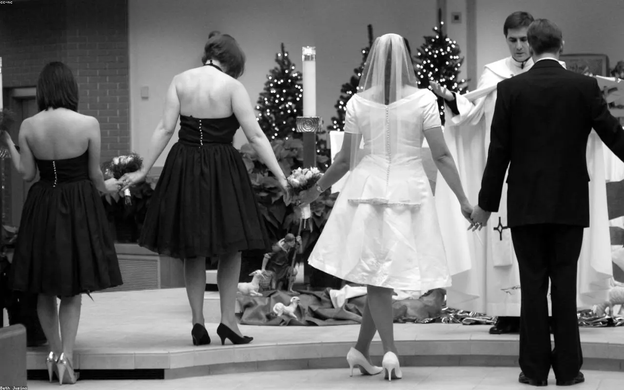 Hands clasped near a soft candle